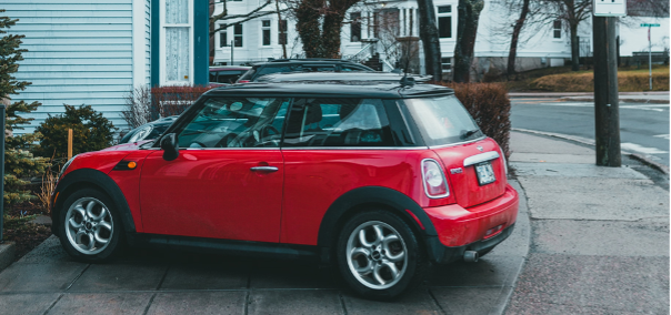 driveway picture of a red mini car